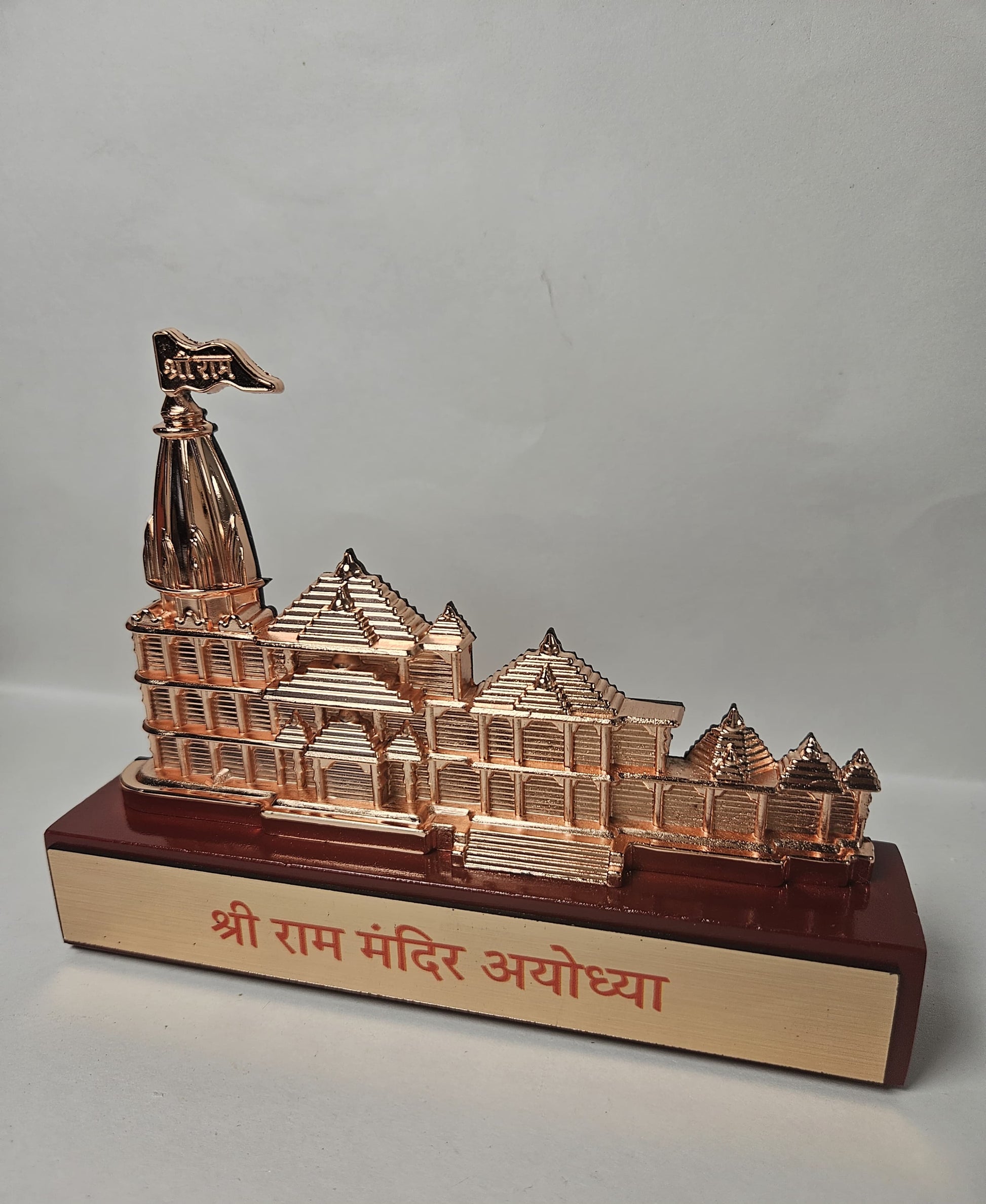 Miniature replica of the iconic Ram Mandir Ayodhya, crafted in a metallic rose gold finish, featuring intricate architectural details.