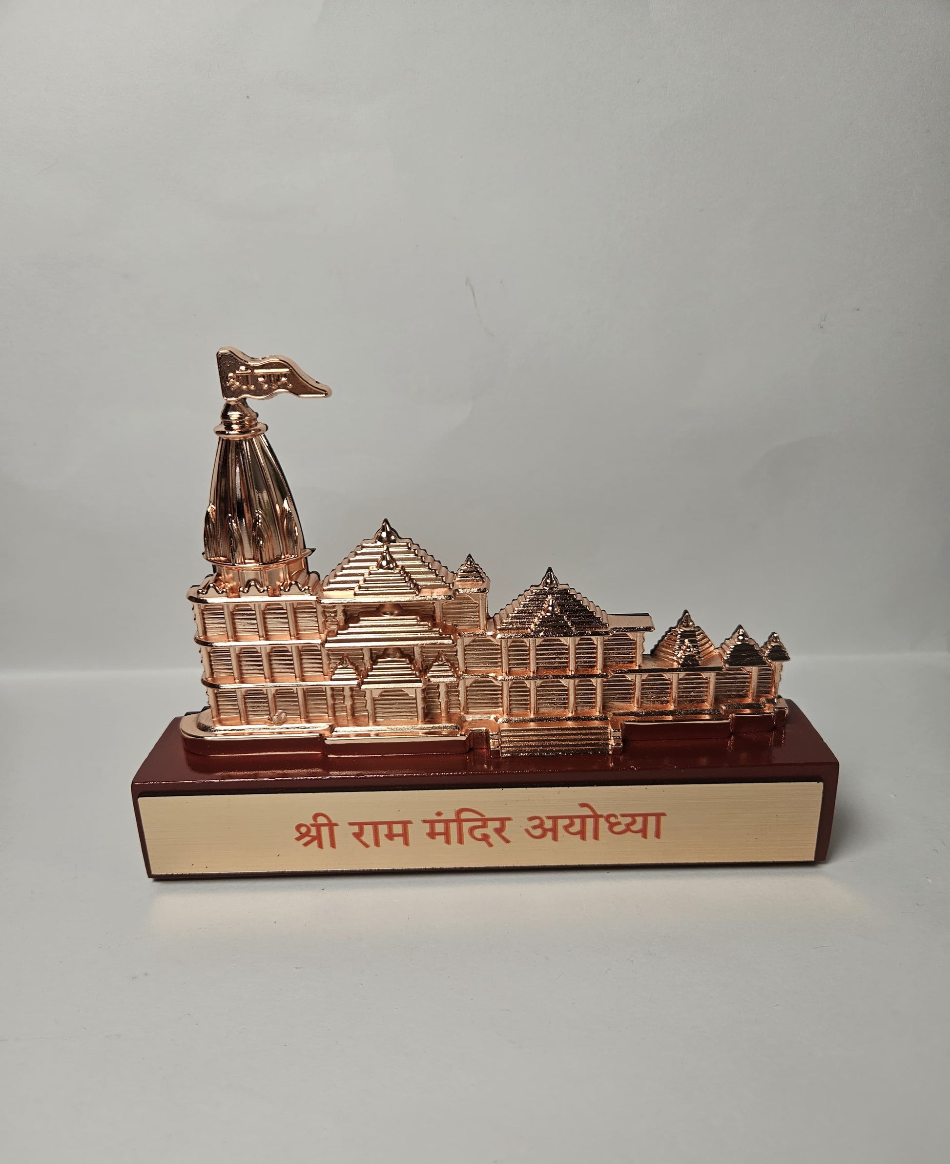 Close-up of a decorative Ram Mandir Ayodhya idol, showcasing its distinct spire, multiple shikharas, and the text 'Shri Ram Mandir Ayodhya' on the base.