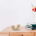 U Shaped Candle Holder on the wooden desk with books on the right side