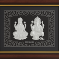 Framed silver Lakshmi and Ganesha idol with ornate border and '999 SILVER' marked below the deities.