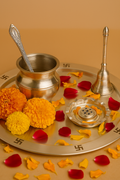 Pooja thali with religious items on a brown background