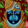 A vibrant and ornate painting of Shrinathji, a form of Krishna, depicted with blue skin, adorned in a gold and jewel-encrusted crown and necklace, set against a rich red background with green leaves and pink lotus flowers.