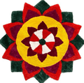 A vibrant, colorful Special Rangoli Mats design is shown against a white background. The intricate circular pattern is made of red, dark red, green, and yellow colored materials, arranged in the shape of a flower with multiple layers of petals.