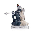 A detailed idol depicting Lord Krishna playing the flute while seated next to Radha, who is adorned with elaborate jewelry and garments, likely a decorative showpiece.