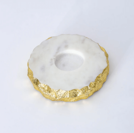 A round marble tea light holder with gold foil accents on a white background.