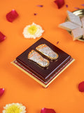 A close-up shot of a decorative item featuring a pair of silver and gold-colored feet impressions, known as 