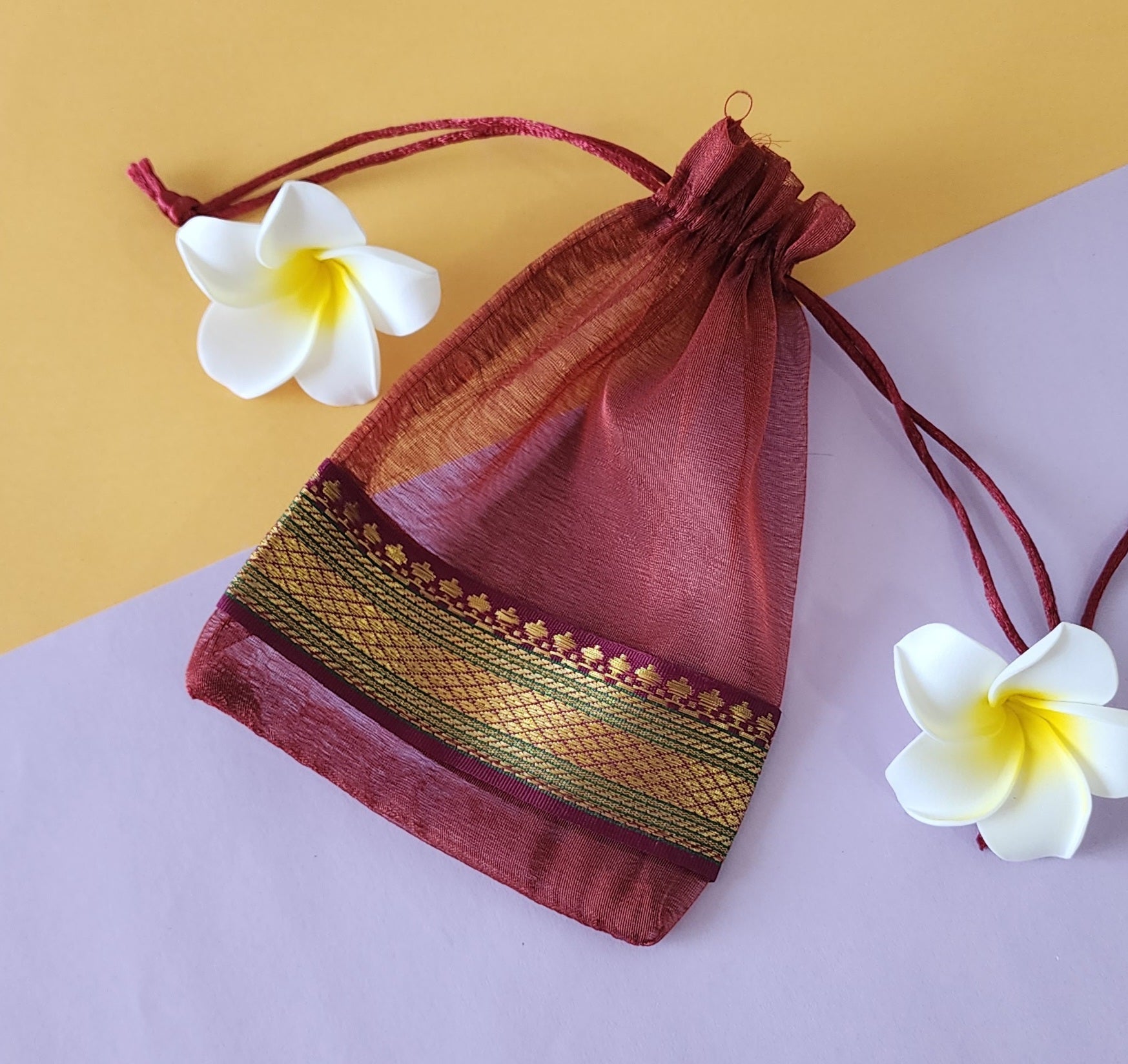 Pink design Organza Potli Bags with flowers around it