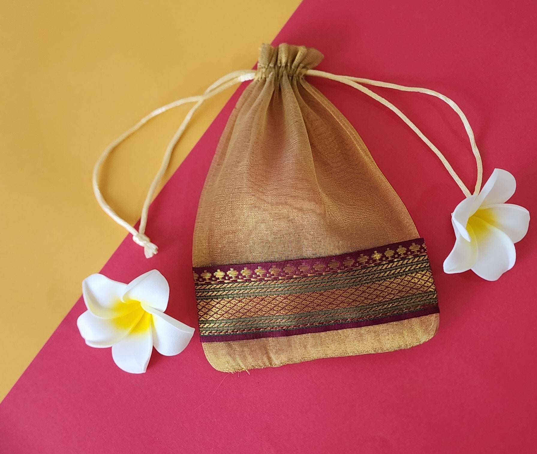 Skin color design Organza Potli Bags with flowers around it