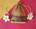 Skin Organza Potli Bags with flowers around it