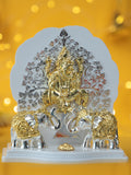 A statue of Ganesha sitting under a Kalpavriksh tree, with two elephants on either side.