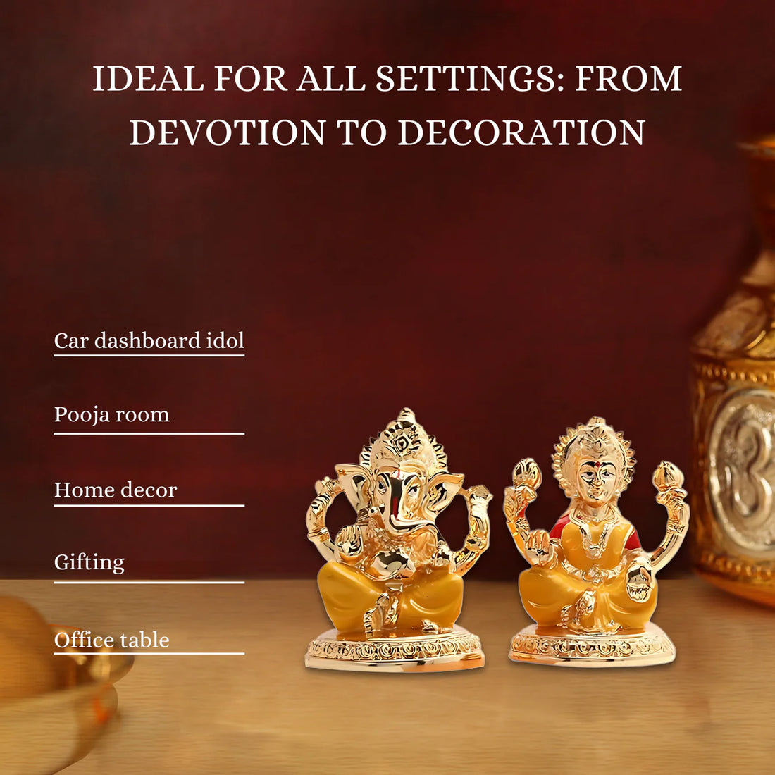 A golden statue of Goddess Lakshmi seated, holding lotuses, next to a golden statue of Lord Ganesha, also seated, with his trunk turned to the left. Both idols are on a reddish-brown surface with a yellow flower garland visible in the background.