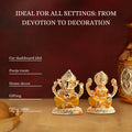 A gold-colored statue set featuring the Hindu deities Ganesha and Lakshmi, sitting side-by-side. The image text describes the statues as ideal for various settings, including car dashboards, pooja rooms, home decor, gifting, and office tables.