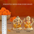 A gold-colored idol of Lord Ganesha and a gold-colored idol of Goddess Lakshmi placed side-by-side, with a ruler showing their dimensions. The text 