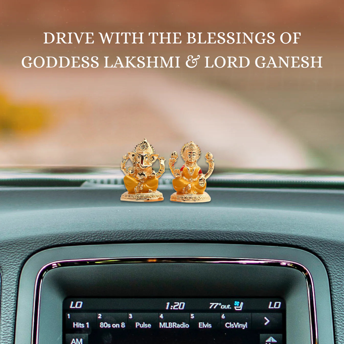 Based on the image, a good alt text would be: "Two small, golden-colored idols of Lord Ganesha and Goddess Lakshmi on the dashboard of a car."