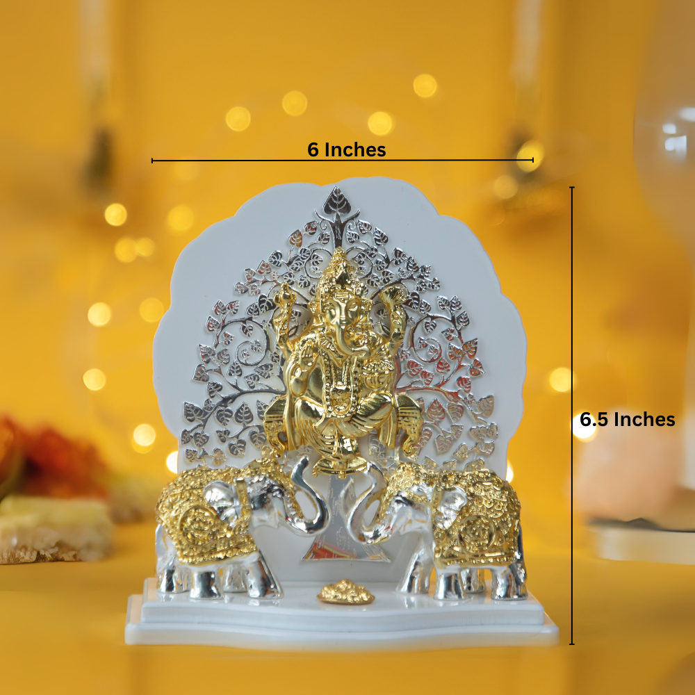 A golden and silver showpiece depicting a Kalpavriksha Tree Ganesha Idol with Lord Ganesha seated in front of a silver and gold tree, flanked by two elephants on a white base.