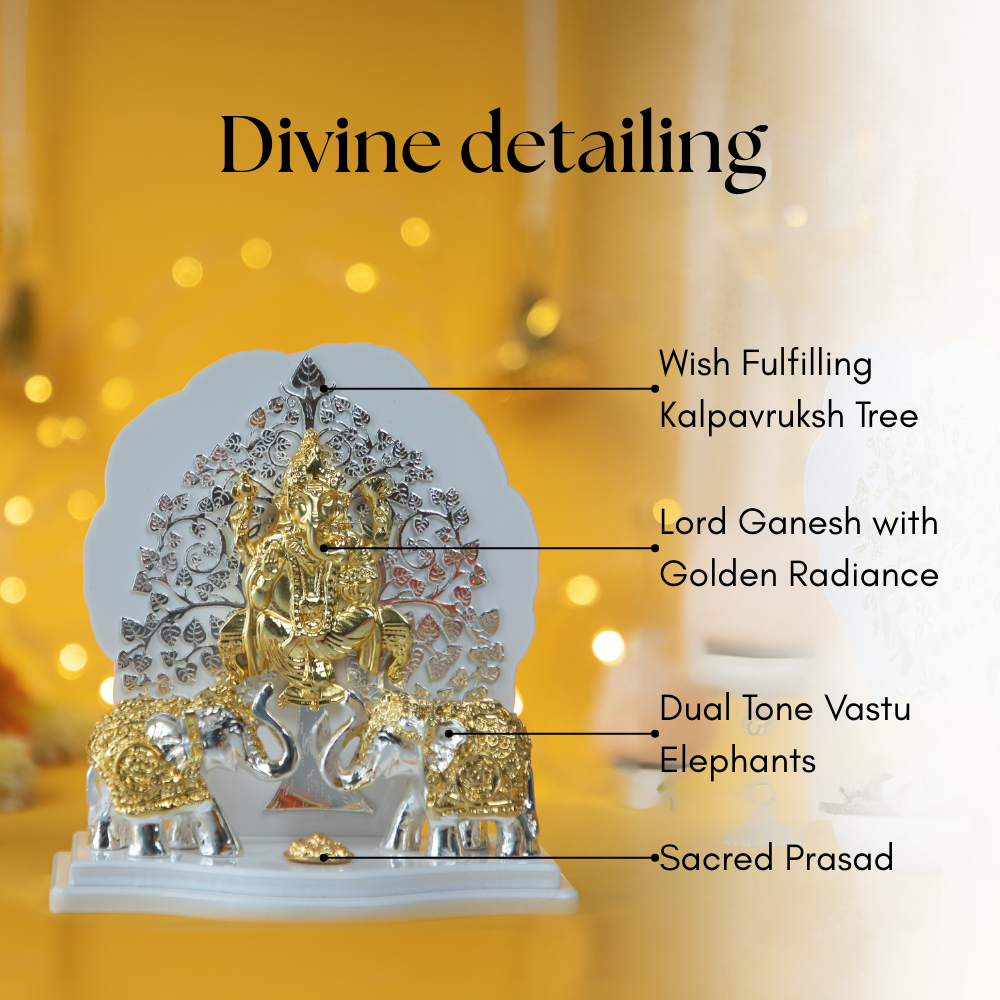 A close-up of a silver and gold-coated idol featuring Lord Ganesh with golden radiance, seated beneath a detailed, wish-fulfilling Kalpavriksh Tree. The idol also includes two dual-tone Vastu elephants and a sacred prasad offering. The background is a soft, golden bokeh