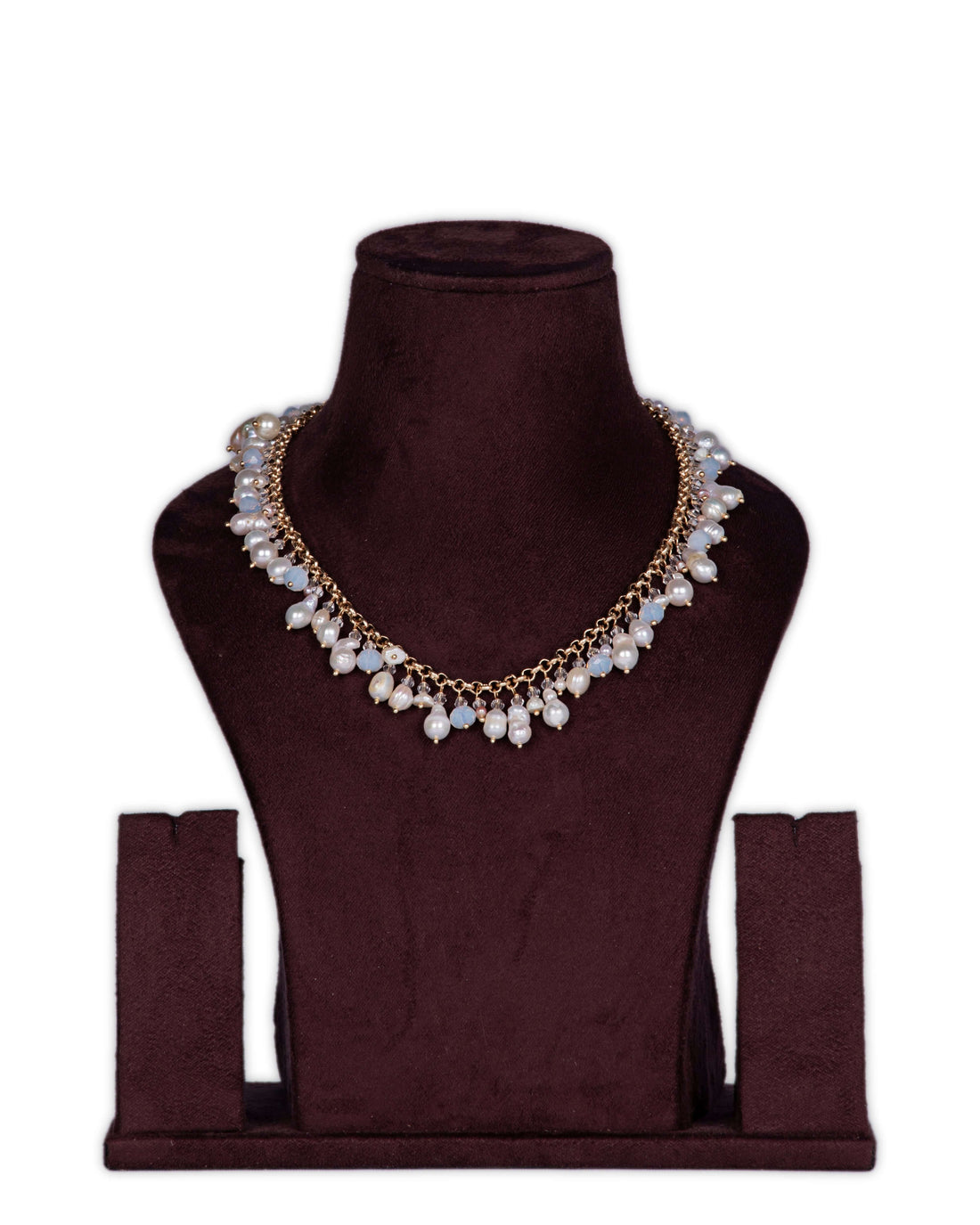 A long baroque pearl and MOP shell pearl necklace displayed on a mannequin bust, with a golden chain and teardrop pendants.