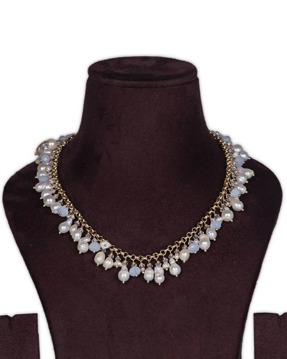 A long baroque pearl and MOP shell pearl necklace displayed on a mannequin bust, with a golden chain and teardrop pendants.